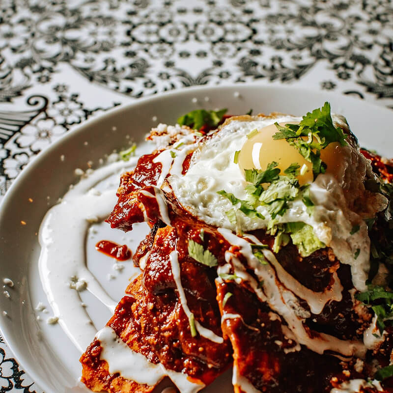 Chilequiles on a white plate.