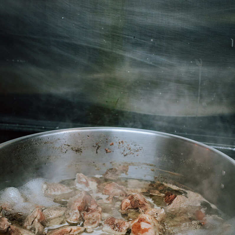 Sauteing meet in a pan.